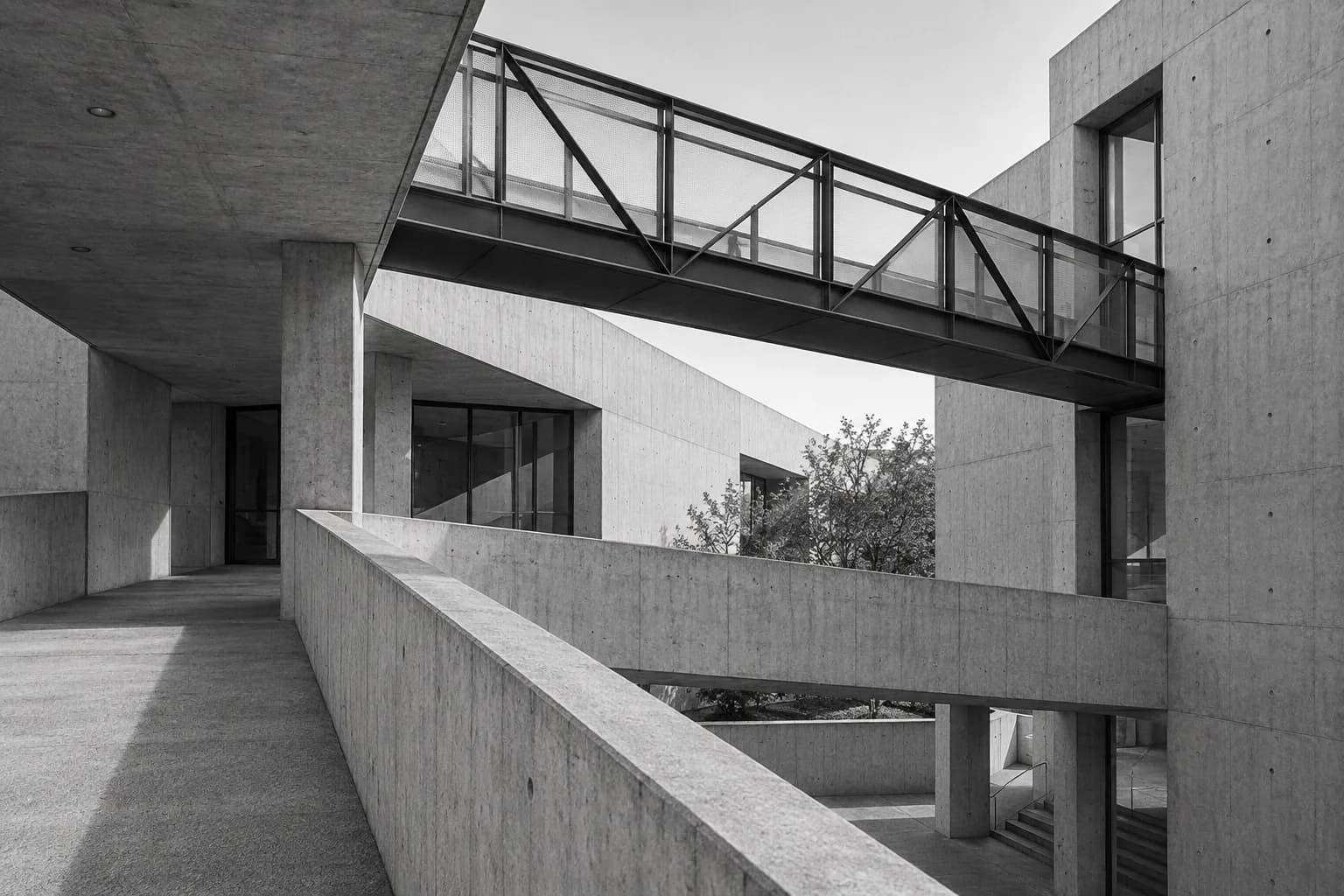 Black-and-white architectural study of walkways connecting several levels.